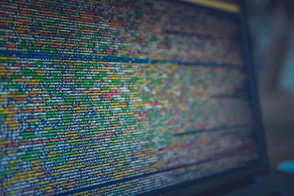 A computer screen displaying dense lines of colorful programming code with different syntax highlighting, indicating software development or web coding activity. The code is arranged in a structured m